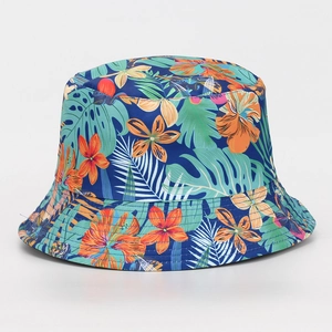 Close-up of vibrant tropical flower and green palm leaf prints on a blue bucket hat