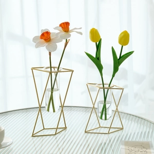 Modern gold geometric metal frame flower vase with glass tubes and fresh tulips