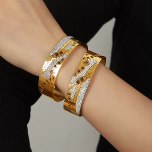 Modern gold hollow flower bangle with sparkling white crystals for a unique jewelry look