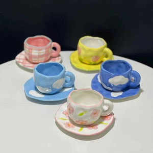 Hand-painted ceramic tulip coffee cup set with plaid and cloud patterns on white table