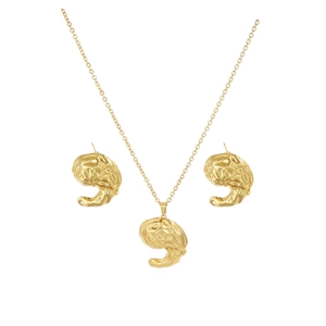 Detailed view of golden heart-shaped hammered metal necklace and earring jewelry set