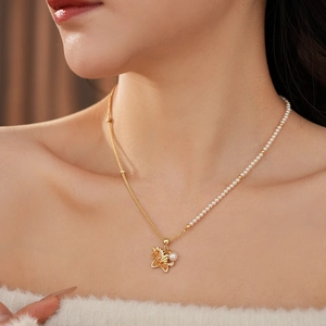 Close-up of elegant gold chain and pearl necklace featuring a detailed Pegasus pendant