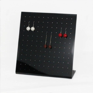 L-shaped black acrylic jewelry stand with multiple holes for earring display and storage