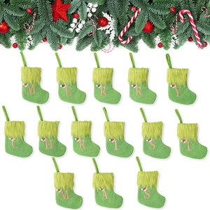 Green knit Christmas stockings with gold alphabet embroidery and plush faux fur cuffs