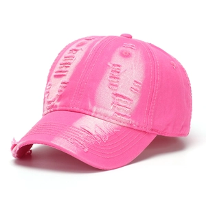 Detail view of hot pink washed denim baseball cap with vintage distressed ripped effects