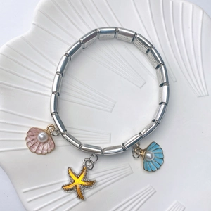 Detail of marine stainless steel bracelet with enamel shell and starfish pendants