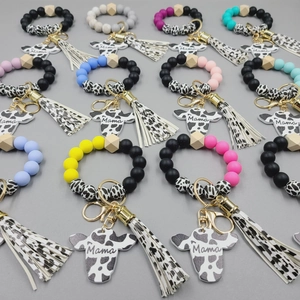 Detailed grid of silicone bead bracelets with Mama cow tags and matching leather tassels