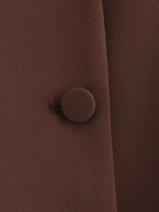Detailed close-up of dark brown woven fabric with a matching fabric-covered button