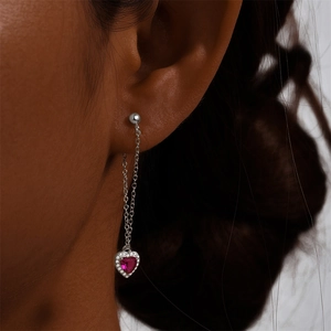 Detail of s925 silver long drop earring with red heart gemstone and zircon halo