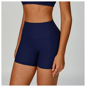 Detail of high-waisted ribbed navy blue sports shorts with seamless compression texture