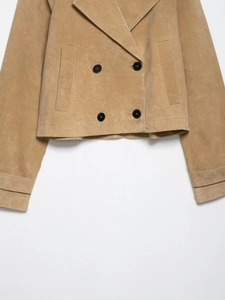 Detail of khaki suede jacket featuring double-breasted buttons and flap pocket design