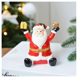 Detailed view of a ceramic Santa Claus jewelry box with golden metallic hinge and festive decor