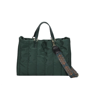Large dark green puffer tote bag with vertical quilting and ethnic style strap