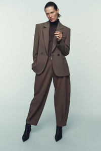 Full-length view of dark coffee two-piece suit with double-breasted blazer and wide-leg pants