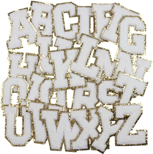 Macro detail of 26 chenille letter patches with gold glitter embroidery for DIY decoration