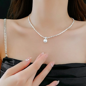 Silver bead necklace with white pearl pendant shown on neck for elegant jewelry styling