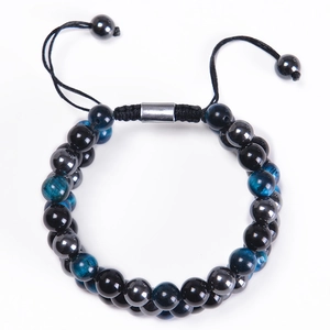 Detailed macro of triple layer tiger eye beads and braided cord on a beaded bracelet