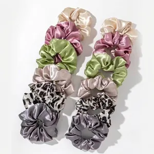 Set of 12 satin hair scrunchies in assorted colors and leopard print patterns