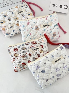 Quilted floral makeup bags with cute puppy and bear prints on marble background