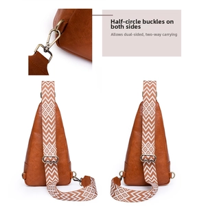 Detail of adjustable geometric strap and dual D-rings on brown PU leather sling bag