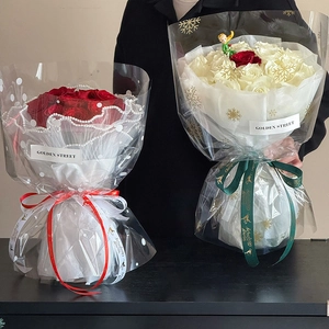 Red and white rose bouquets in snowflake cellophane wrap with pearl chain and ribbons