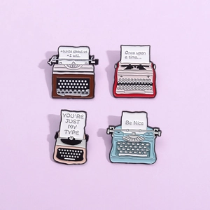 Set of 4 vintage typewriter enamel pins in red, brown, pink and blue colors