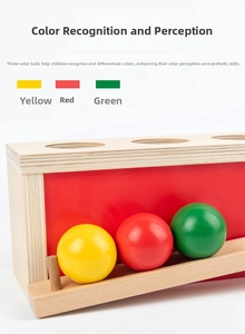 Close-up of wooden color sorting box with three holes and matching colored solid wood balls
