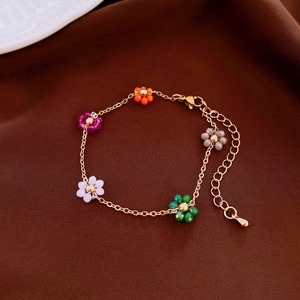 Gold-plated chain bracelet with five colorful beaded flower charms and lobster clasp