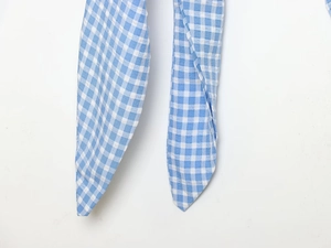 Detailed close-up showing the blue and white gingham fabric texture and stitching quality