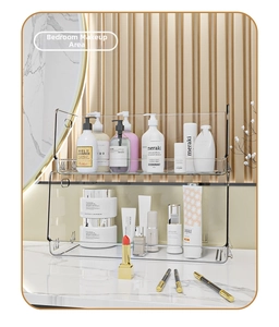 Modern two-tier clear acrylic makeup organizer with integrated handles on marble surface