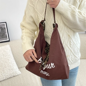 Detail of the leopard print lining and white Bonjour magic text on the brown canvas tote bag