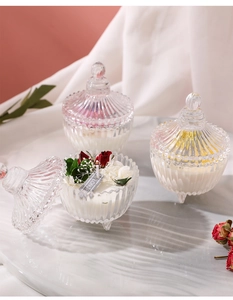 Detail of vintage ribbed glass candles with dried flowers on a marble tray