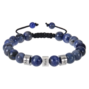 Macro detail of custom engraved stainless steel beads on blue sodalite woven bracelet