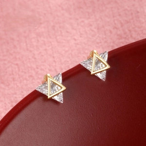 Macro shot of 24k gold-plated triangular earrings with large clear cubic zirconia stones