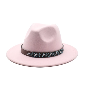 Detail of light pink wool fedora featuring ethnic style beaded hatband and classic crown