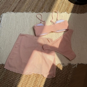 Detailed close-up of honeycomb textured fabric on light pink three-piece bikini set