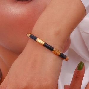 Detail of 18K gold-plated stainless steel bamboo bracelet with black enamel finish