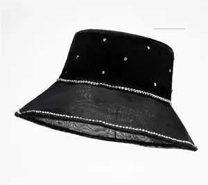 Close-up of black satin bucket hat with rhinestone embellishments and sheer mesh brim