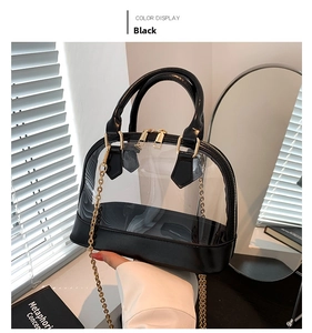 Detail view of transparent PVC shell bag with black leather trim and golden metal chain