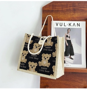 Detail of cute bear printed linen lunch bag showing woven fabric texture and handle