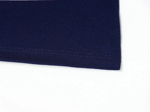 Close-up of high-quality navy blue fabric with professional double-stitched hem finish