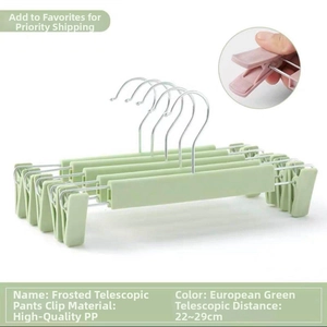 Detail of adjustable green plastic pants hangers with 22-29cm telescopic function