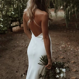 Elegant backless white satin wedding dress with deep V-neck and thin straps in forest