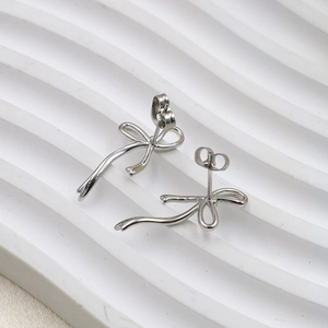 Elegant silver bow stud earrings for women with minimalist metallic finish and texture
