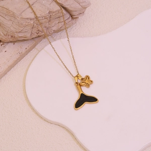 Golden stainless steel necklace featuring black whale tail and butterfly charms