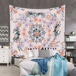 Detail of bohemian mandala tapestry featuring purple floral patterns on a bedroom wall