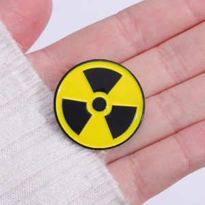Classic yellow and black circular radiation symbol enamel pin badge in metal
