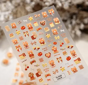 Close-up of 5D embossed nail stickers featuring caramel bears and red heart patterns