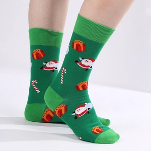 Green Christmas crew socks with Santa Claus, gift boxes, and candy cane patterns