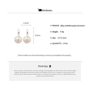 Detailed view of silver needle C-shaped earrings with white pearls and star zircons